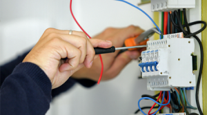 Electric Car Charger Installation with hands on a screwdriver in Coral Springs. 