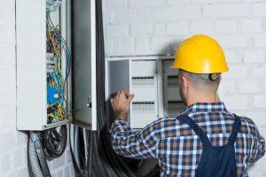 Electrician doing some electrical repairs on a transformer box in Fort Lauderdale 