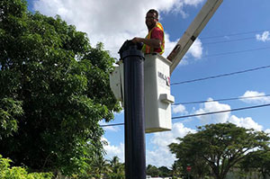 Man on a powerline working on an electrical Repair in Sunrise